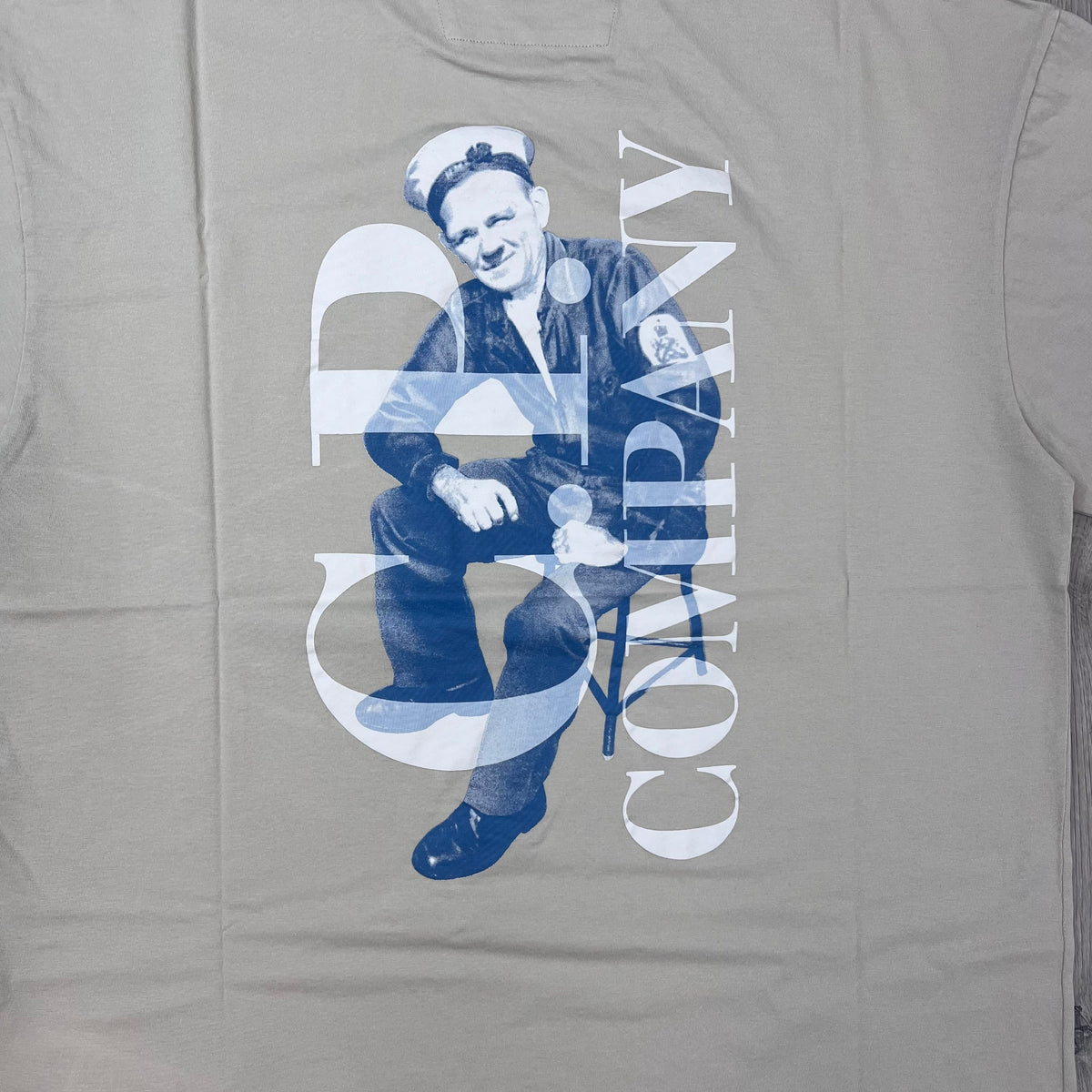 Close up view of the large printed logo on the rear of a CP Company 30/1 Jersey Sailor T-Shirt in Silver Birch.