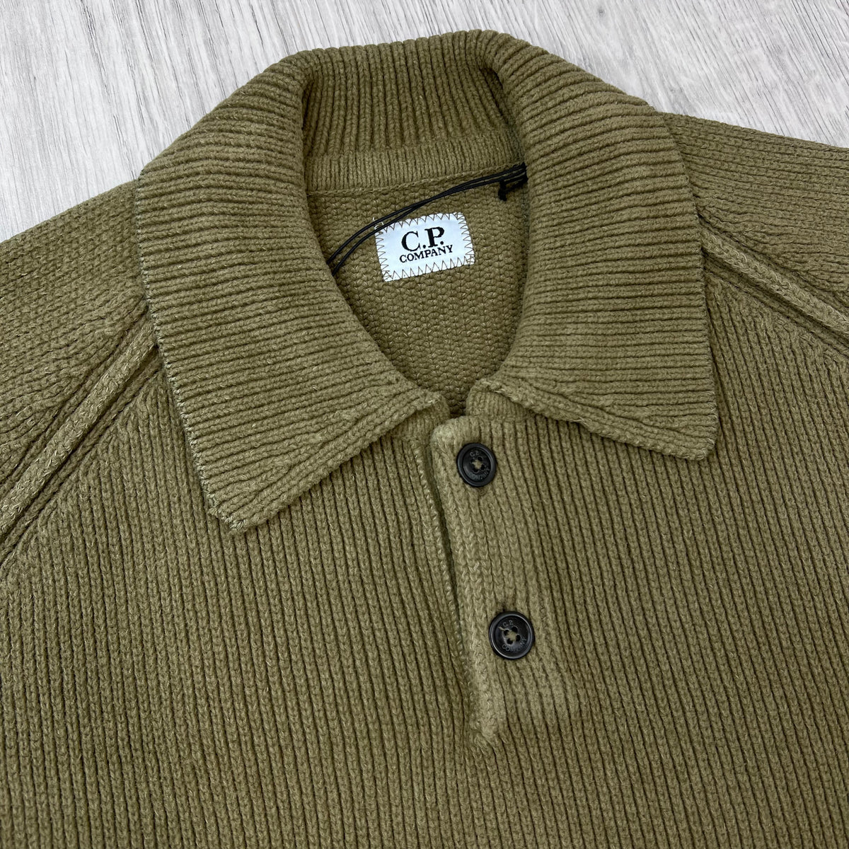 Close up view of the 2-button placket and folded collar on a CP Company Chenille Knit Polo Sweatshirt in Ermine.