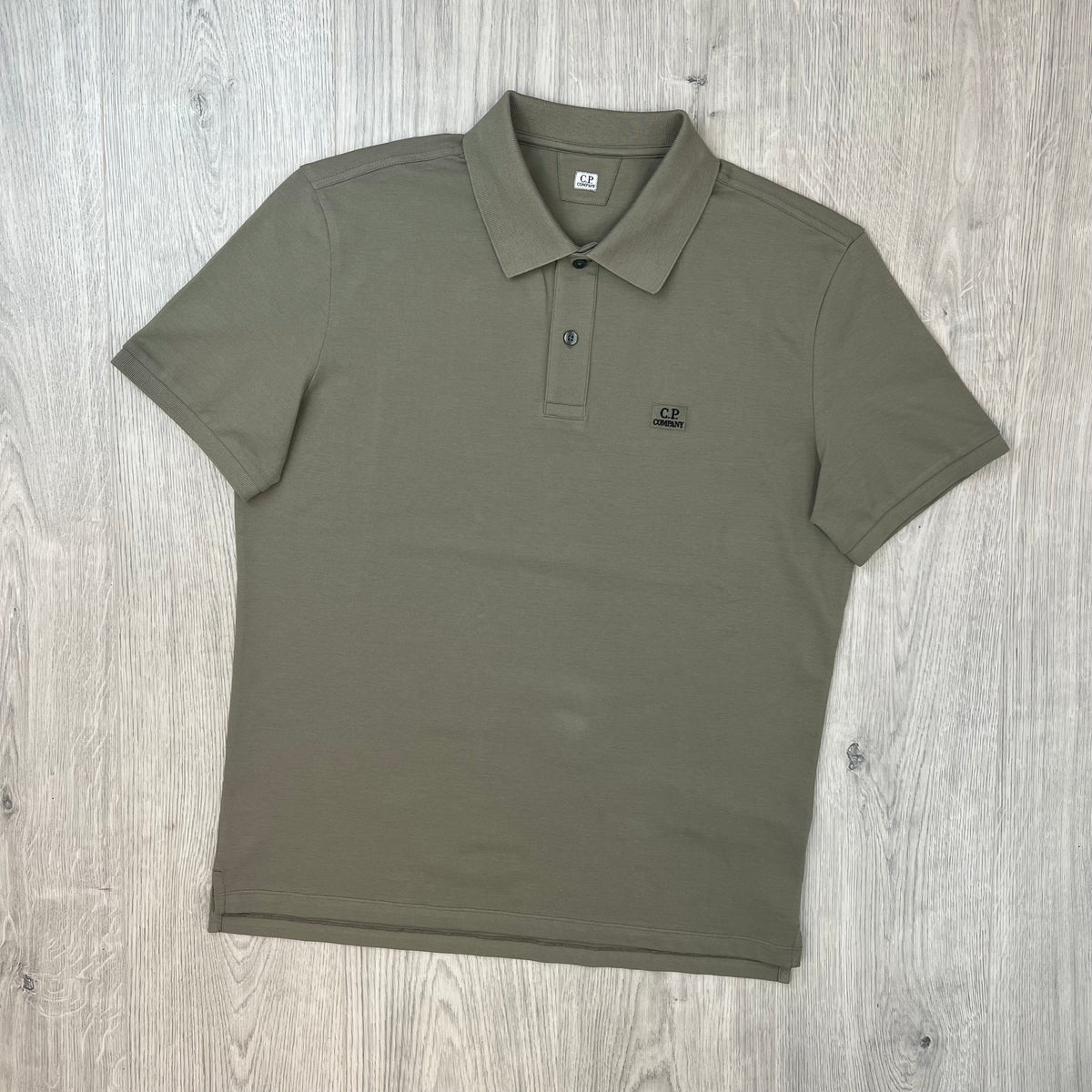 Front view of the CP Company Stretch Piquet Polo Shirt in Fallen Rock.