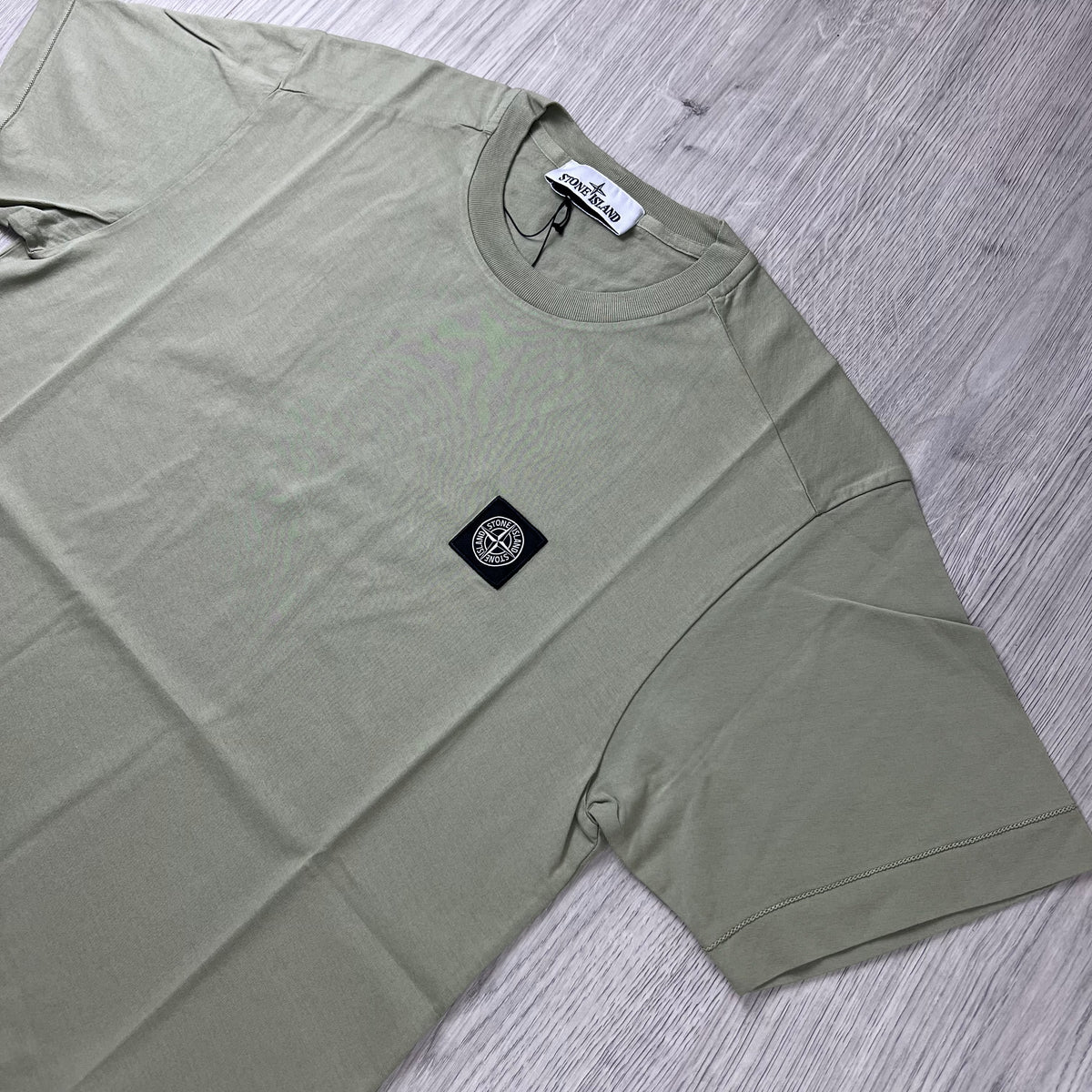 Angled view of the Stone Island 30/1 Patch T-Shirt in Laurel Green.