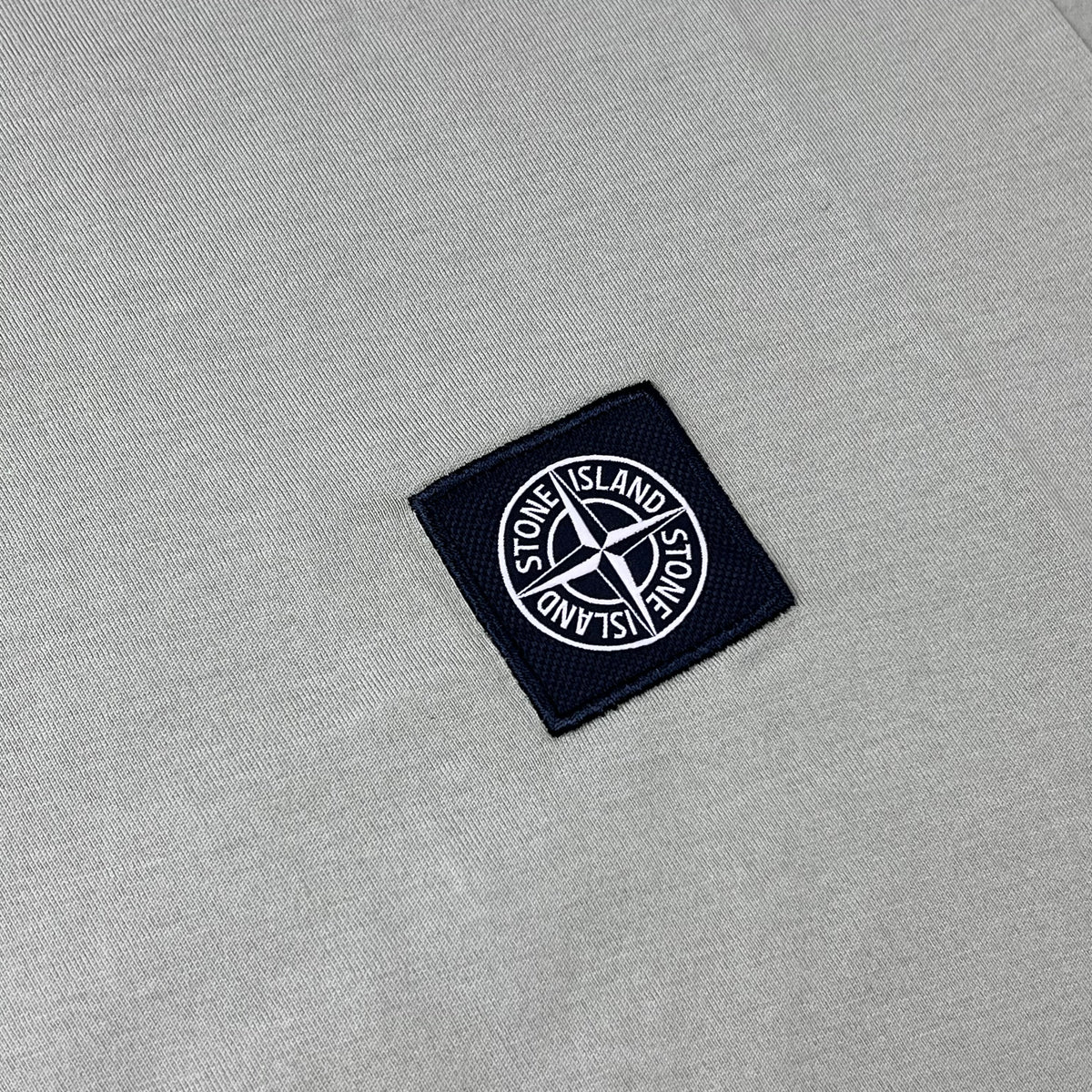 Close up view of the Compass logo on a Stone Island 30/1 Patch T-Shirt in Laurel Green.