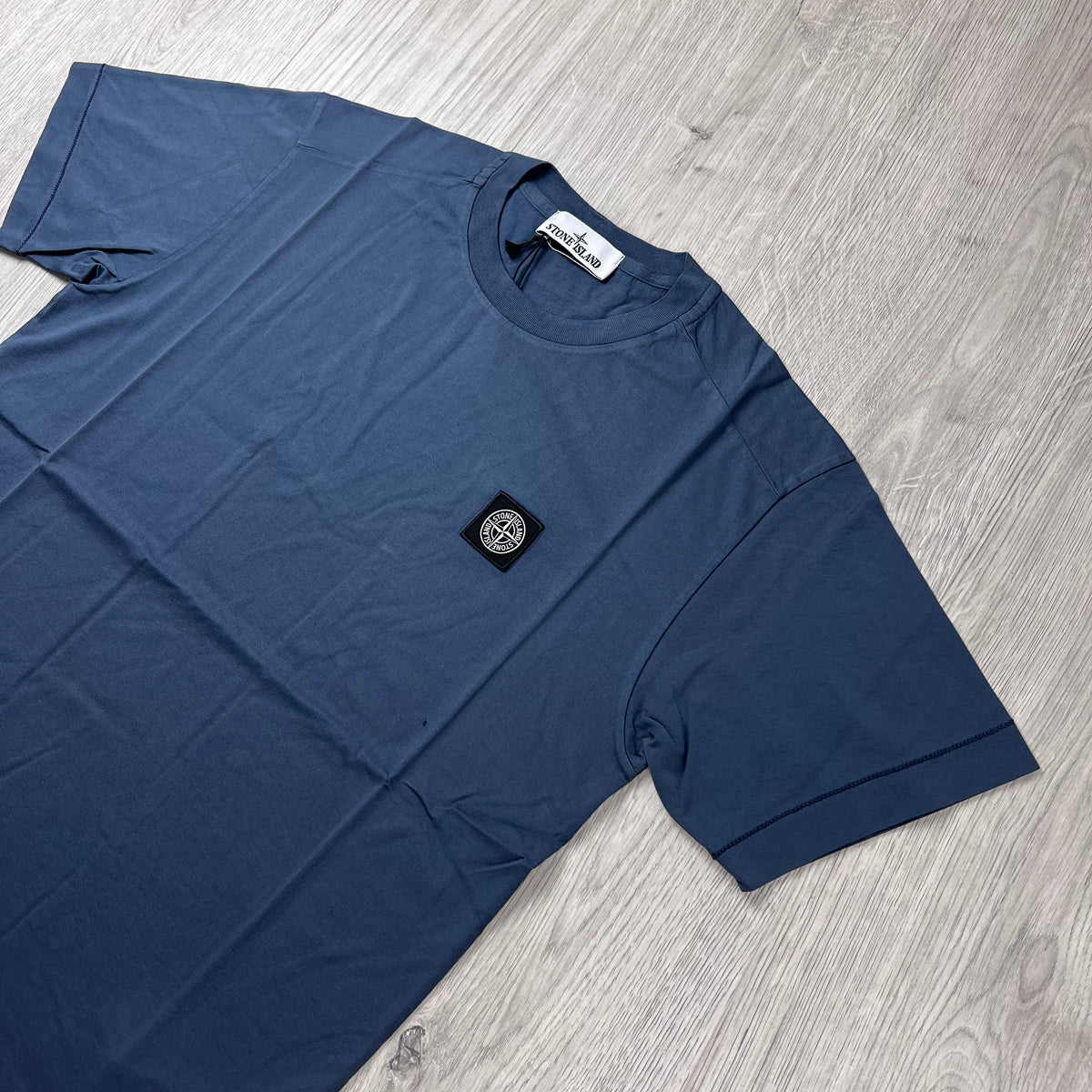 Angled view of the Stone Island 30/1 Patch T-Shirt in Slate Blue.
