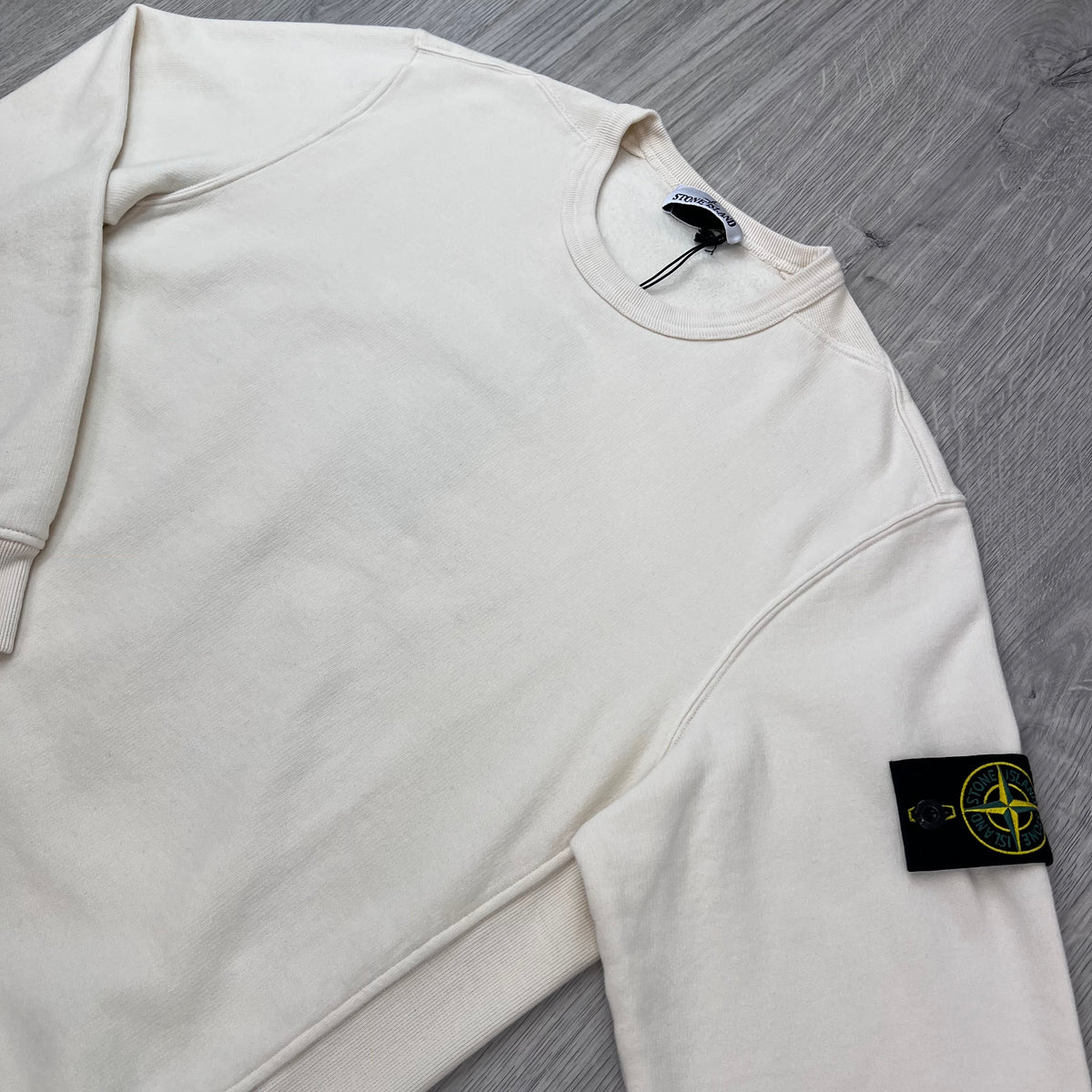 Angled view of the Stone Island Crewneck Brushed Cotton Sweatshirt in Ivory.