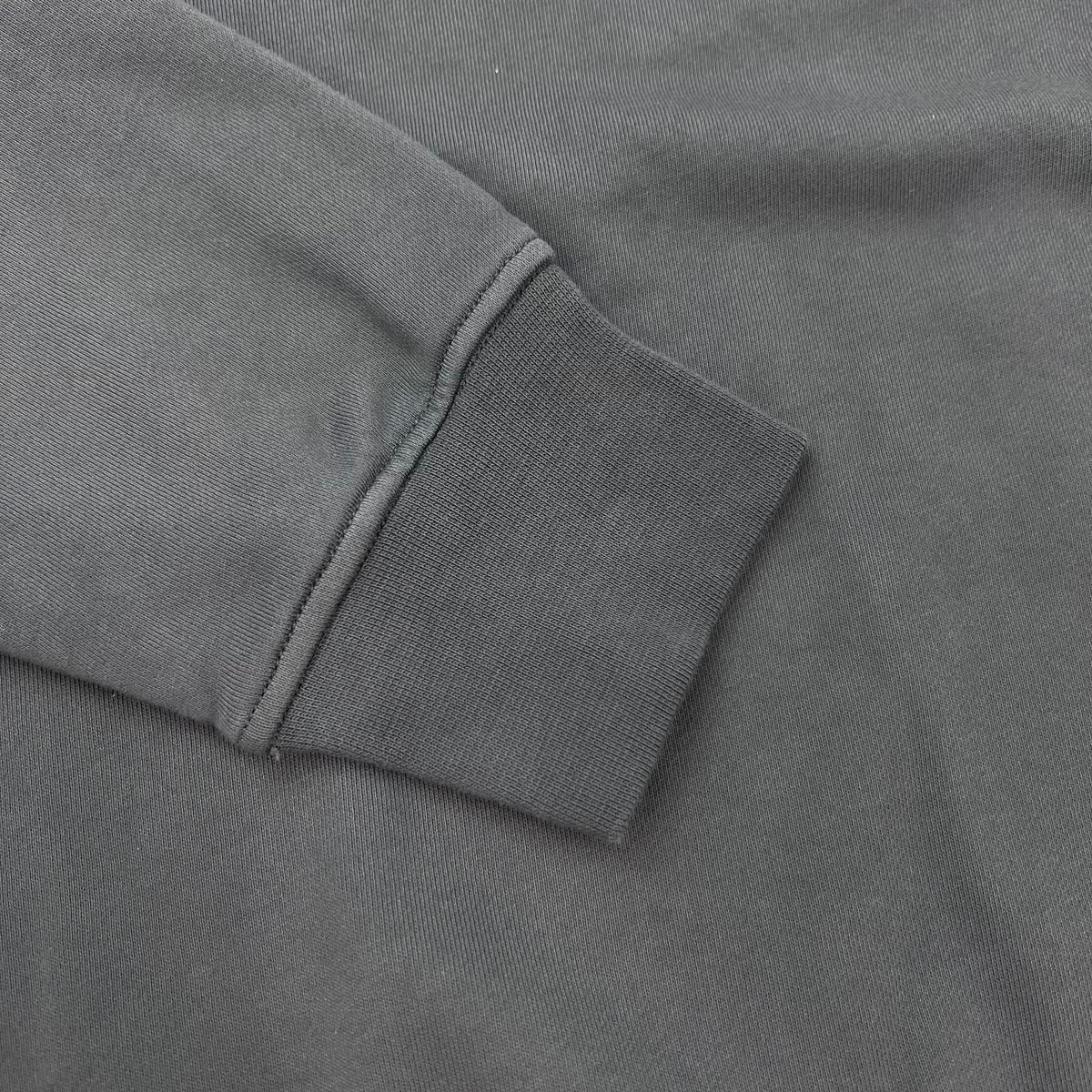 A close up view of the cuffs on a Stone Island Crewneck Sweatshirt in Slate Blue.