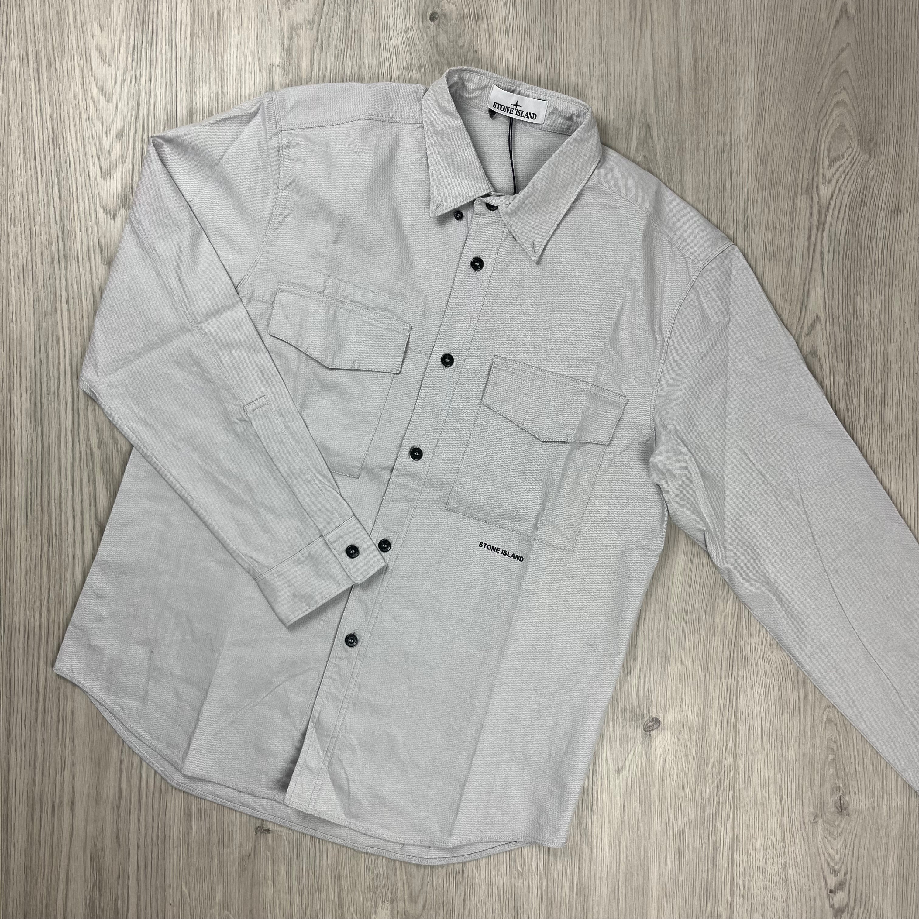 Men's Stone Island button shirt in Dust Grey with dual chest pockets and midriff logo. On sale at Open Attire.