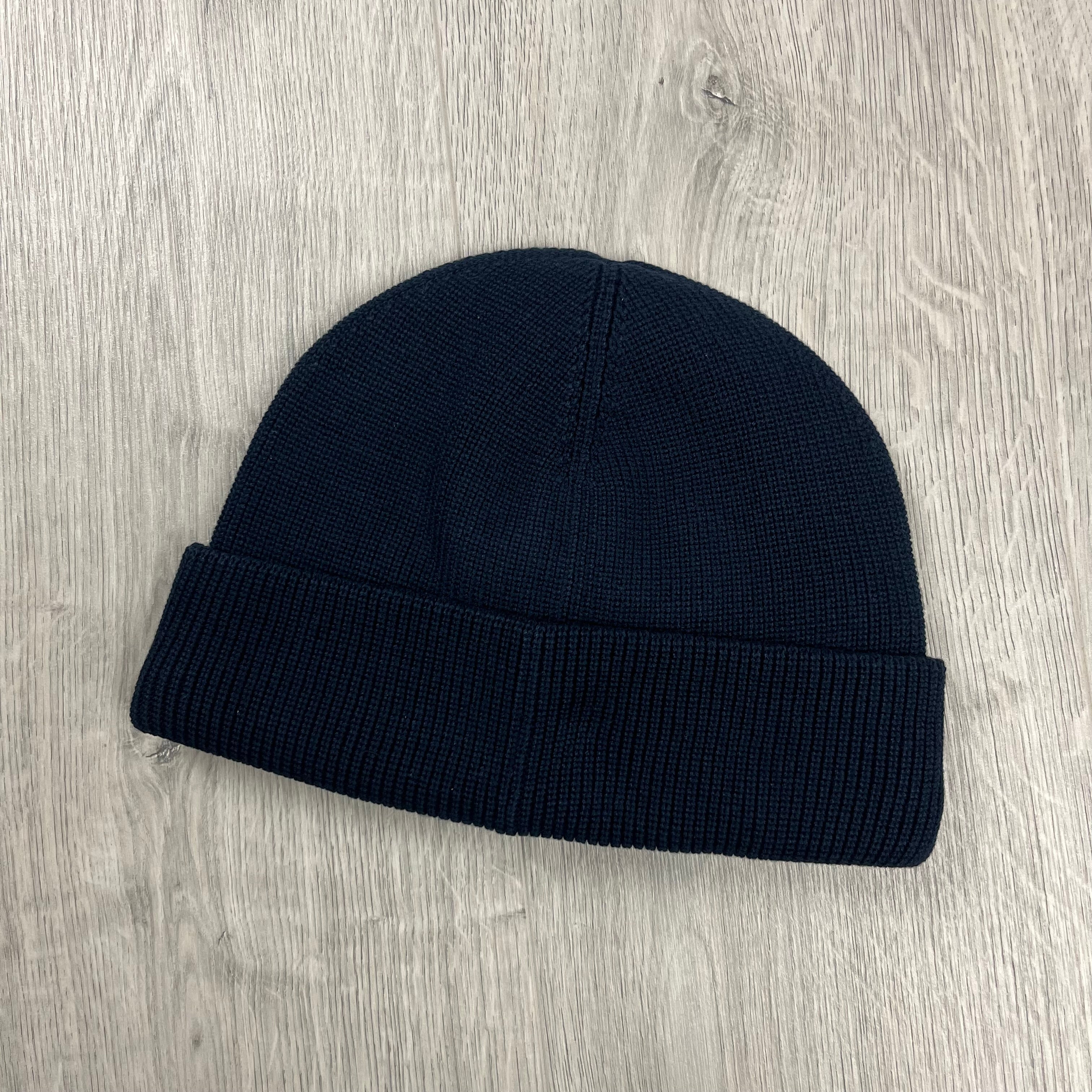 Back of a men's Stone Island beanie with a flat ribbed cuff. On sale at Open Attire.