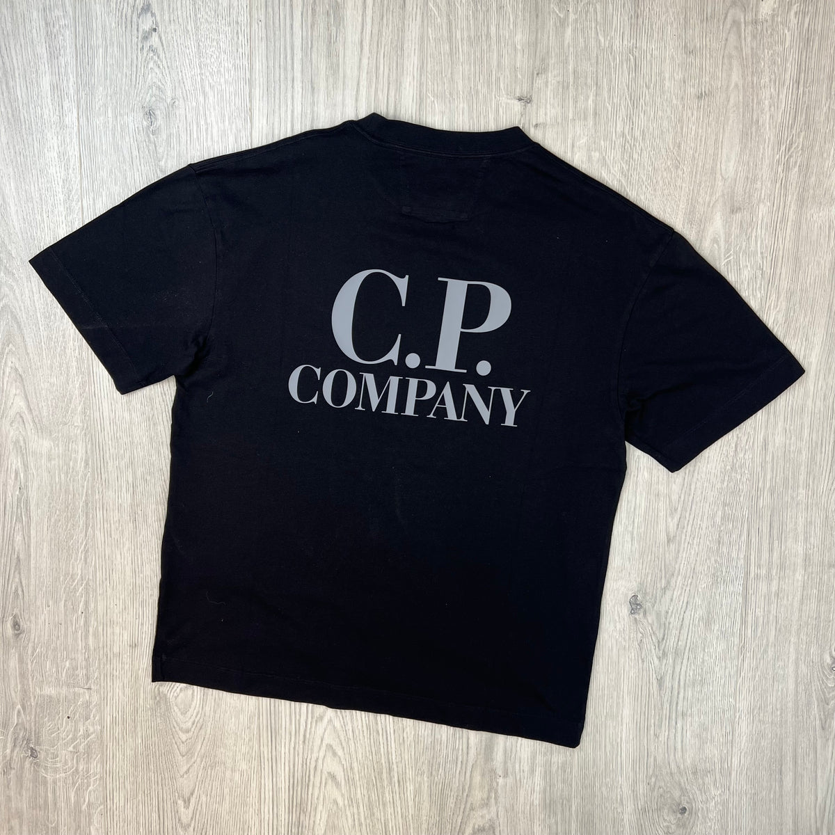 Rear view of a CP Company 30/1 Logo T-Shirt in Black. 