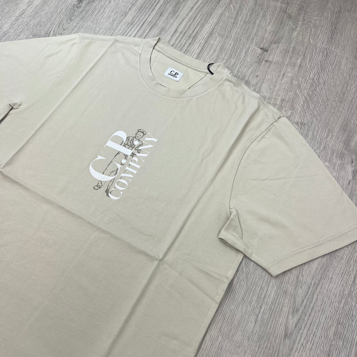 Angled view of a CP Company 30/1 Sailor T-Shirt in Silver Birch. 
