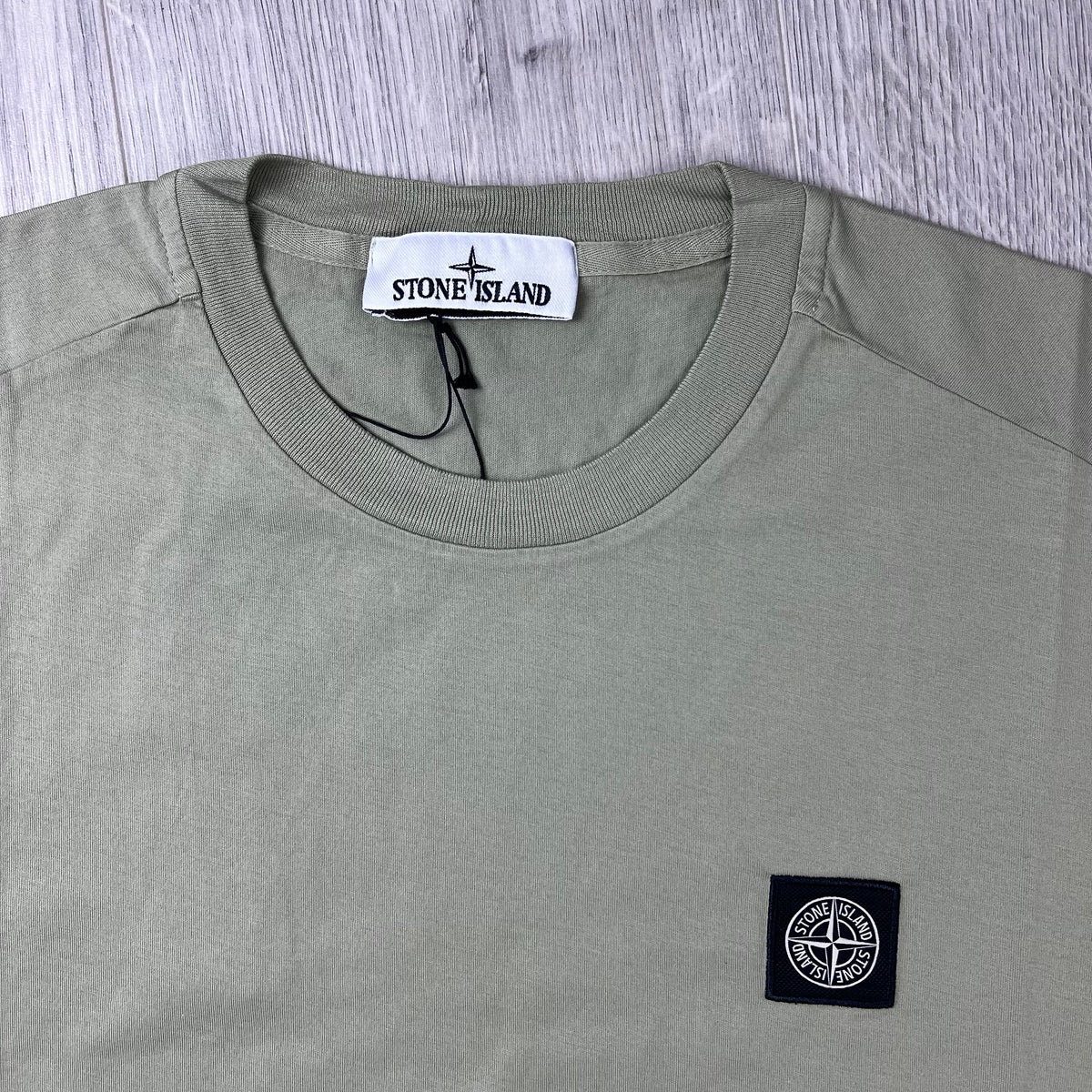 Close up view of the crewneck collar on a Stone Island 30/1 Patch T-Shirt in Laurel Green.