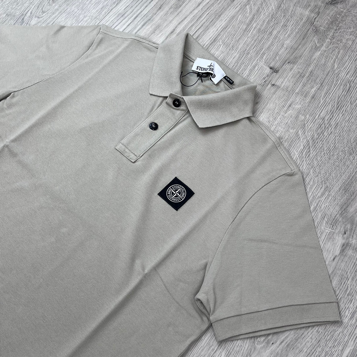 Angled view of the Stone Island Patch Polo Shirt in Sand.