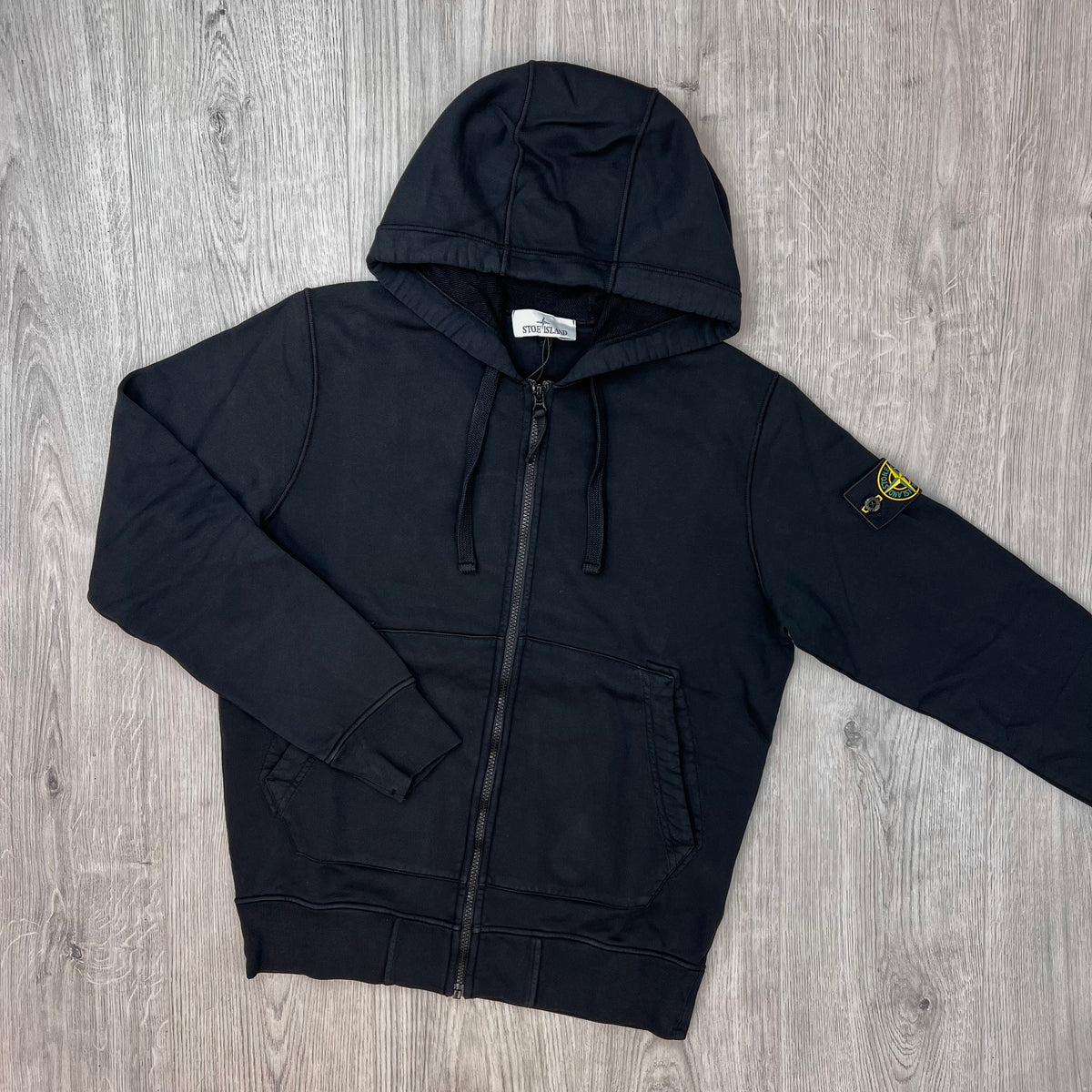 Front view of the Stone Island Zip Hoodie in Black. 